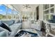 Relaxing sunroom features comfortable seating, ceiling fan, and views of the backyard at 550 Tidewater Chase Ln, Summerville, SC 29486