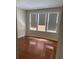 Sunny bedroom featuring hardwood floors and three large, bright windows at 56 Laurens St, Charleston, SC 29401