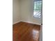 Bedroom with hardwood flooring, neutral walls, and view of trees outside window at 56 Laurens St, Charleston, SC 29401