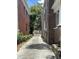 Driveway in between brick apartment buildings with a stone wall visible at 56 Laurens St, Charleston, SC 29401