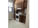 Kitchen with wooden cabinets, white appliances, and brick backsplash at 56 Laurens St, Charleston, SC 29401