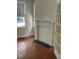 Room featuring hardwood floors, a window, and a traditional fireplace at 56 Laurens St, Charleston, SC 29401