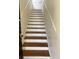 Interior staircase with hardwood steps and white trim detail, leading upstairs at 56 Laurens St, Charleston, SC 29401