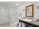 Well-lit bathroom with walk-in shower, granite countertop, and decorative mirror at 5800 Palmetto Dr # R-Vg102, Isle of Palms, SC 29451