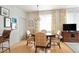 Charming dining room with hardwood floors, chandelier, and seating for six at 5800 Palmetto Dr # R-Vg102, Isle of Palms, SC 29451