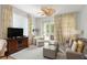Comfortable living room featuring stylish decor, a ceiling fan, and a sliding door to the balcony at 5800 Palmetto Dr # R-Vg102, Isle of Palms, SC 29451