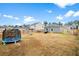Large fenced backyard with trampoline, offering plenty of space for outdoor activities at 604 Red Mulberry Rd, Moncks Corner, SC 29461