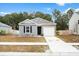 Charming single-story home with a driveway and a well maintained lawn on a sunny day at 604 Red Mulberry Rd, Moncks Corner, SC 29461