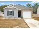 Charming single-story home featuring vinyl siding, brick accents, and an attached one car garage at 604 Red Mulberry Rd, Moncks Corner, SC 29461
