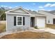 Lovely single-story home featuring gray siding, black shutters, and an attached one car garage at 604 Red Mulberry Rd, Moncks Corner, SC 29461