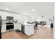 Bright, open kitchen featuring stainless steel appliances, white cabinets, and hardwood flooring at 604 Red Mulberry Rd, Moncks Corner, SC 29461