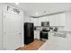 Well-lit kitchen featuring white cabinets, modern appliances, and a pantry for ample storage at 604 Red Mulberry Rd, Moncks Corner, SC 29461