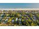 Aerial view of a beach community showcasing homes nestled among the trees along the ocean at 608 W Beach Ct, Folly Beach, SC 29439