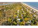 An aerial view of a coastal neighborhood offering both ocean and marsh views at 608 W Beach Ct, Folly Beach, SC 29439