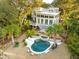 Aerial view of a home with a sparkling pool and mature landscaping at 608 W Beach Ct, Folly Beach, SC 29439