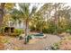 Landscaped backyard featuring a pool, spa, palm trees and mature landscaping at 608 W Beach Ct, Folly Beach, SC 29439