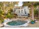 Beautiful home with a pool and spa, set among palm trees and lush landscaping at 608 W Beach Ct, Folly Beach, SC 29439