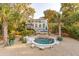 Charming home with a swimming pool, spa, and palm trees offering a relaxing oasis at 608 W Beach Ct, Folly Beach, SC 29439