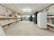 Unfinished basement space with built-in shelving, refrigerator, and ample storage options at 608 W Beach Ct, Folly Beach, SC 29439