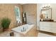 A spa-like bathroom with a soaking tub, sleek fixtures, and a serene ambiance at 608 W Beach Ct, Folly Beach, SC 29439