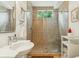 Bathroom with tiled shower and sliding glass doors, offering a modern design with natural light at 608 W Beach Ct, Folly Beach, SC 29439