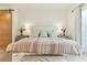 Bedroom with a beautifully styled bed and furnishings illuminated by sconce lighting at 608 W Beach Ct, Folly Beach, SC 29439
