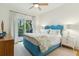 Stylish bedroom with blue accents, white furniture, and access to an outdoor deck at 608 W Beach Ct, Folly Beach, SC 29439