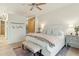Airy bedroom featuring a ceiling fan, comfortable bed, and sliding barn door at 608 W Beach Ct, Folly Beach, SC 29439