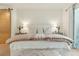 Bright bedroom featuring a large bed, stylish lamps, and a sliding barn door at 608 W Beach Ct, Folly Beach, SC 29439