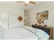 Comfortable bedroom with nautical decor, a dresser, and double closets for ample storage at 608 W Beach Ct, Folly Beach, SC 29439