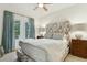Cozy bedroom with decorative headboard, natural light, and neutral decor at 608 W Beach Ct, Folly Beach, SC 29439