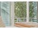Balcony view from bedroom features a natural wooded landscape at 608 W Beach Ct, Folly Beach, SC 29439