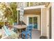 Outdoor deck with dining area and grill, perfect for alfresco meals and entertaining guests at 608 W Beach Ct, Folly Beach, SC 29439