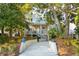 Charming two-story home featuring a welcoming front porch and landscaped yard at 608 W Beach Ct, Folly Beach, SC 29439