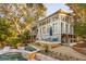 Stunning exterior view of a modern home with multiple decks, lush landscaping, and an inviting pool at 608 W Beach Ct, Folly Beach, SC 29439