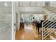 Grand foyer showcasing soaring ceilings, an open staircase, beautiful wood floors and a glimpse into the spacious living area at 608 W Beach Ct, Folly Beach, SC 29439