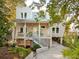 Charming stilted home with a front porch, landscaped yard and ample parking at 608 W Beach Ct, Folly Beach, SC 29439
