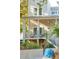 Charming front porch with modern railings and lush landscaping at 608 W Beach Ct, Folly Beach, SC 29439