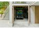 Golf cart garage with a charming green cart inside at 608 W Beach Ct, Folly Beach, SC 29439