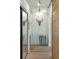 Well-lit hallway with decorative art pieces and a modern sliding barn door at 608 W Beach Ct, Folly Beach, SC 29439