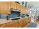 Well-equipped kitchen featuring modern cabinetry, stainless steel appliances, and a stylish backsplash at 608 W Beach Ct, Folly Beach, SC 29439