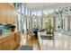 Bright and airy kitchen with hardwood floors, an island sink, and views into the dining and living spaces at 608 W Beach Ct, Folly Beach, SC 29439