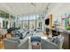 Bright and airy living room with large windows, fireplace, and comfortable seating arrangement at 608 W Beach Ct, Folly Beach, SC 29439