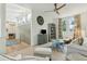 Living room with ceiling fan, light walls, and railing leading to upper level at 608 W Beach Ct, Folly Beach, SC 29439