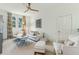 Bright living room featuring neutral colors, ceiling fan, and plenty of natural light from large windows at 608 W Beach Ct, Folly Beach, SC 29439