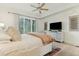Main bedroom features ensuite bathroom, ceiling fan, and access to a balcony at 608 W Beach Ct, Folly Beach, SC 29439