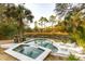 Beautiful outdoor pool area featuring a jacuzzi, stone patio and serene backyard at 608 W Beach Ct, Folly Beach, SC 29439