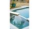 In-ground pool and jacuzzi featuring decorative tiles and stone accents at 608 W Beach Ct, Folly Beach, SC 29439