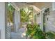 Charming covered porch with decorative plants, creating a welcoming and tranquil atmosphere at 608 W Beach Ct, Folly Beach, SC 29439