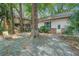 Backyard patio with mature trees and a house exterior featuring a deck and staircase at 6094 Chisolm Rd, Johns Island, SC 29455
